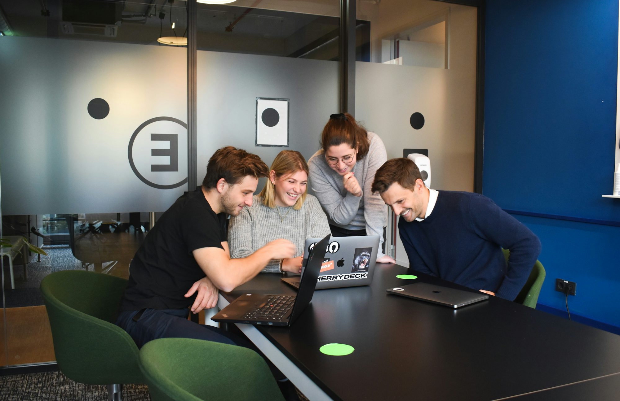 Members collaborating around a device prototype